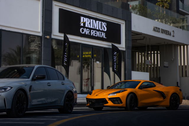 Primus Car Rental office in Dubai with supercars parked outside